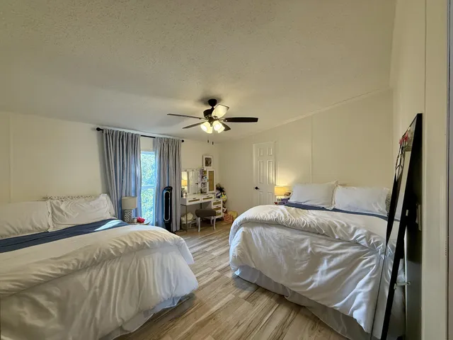 a bedroom with two beds and a chandelier
