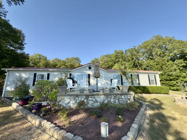 a roof deck with table and chairs potted plants with sky view