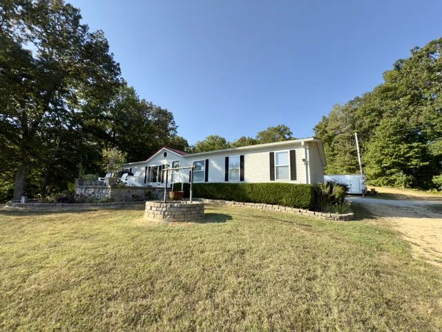 a front view of a house with yard and porch