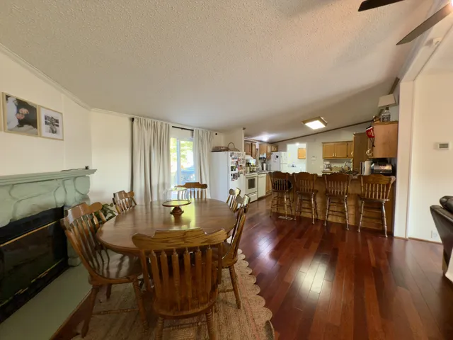 a view of a a dining room with furniture and wooden floor