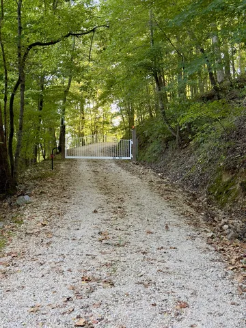 a view of a yard with wooden fence