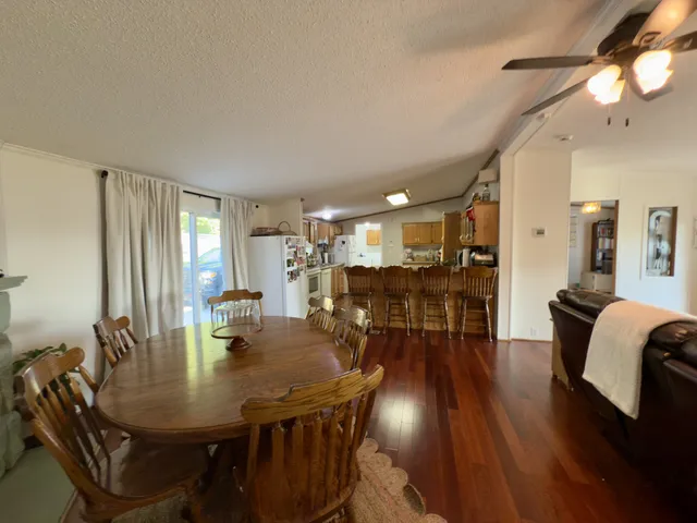 a living room with furniture a ceiling fan and a window