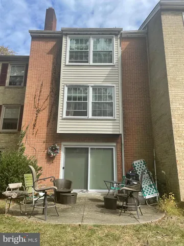 a front view of a house with outdoor seating