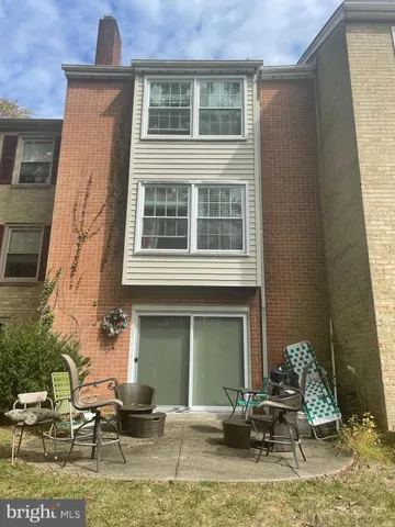 a front view of a house with outdoor seating