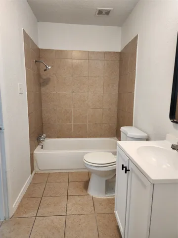 a bathroom with a sink a toilet and a bathtub