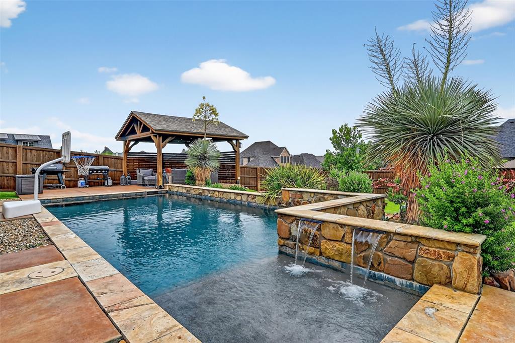 a view of a house with pool and ocean view