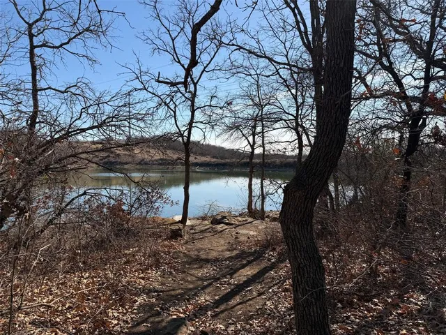 a view of a lake with houses in the back