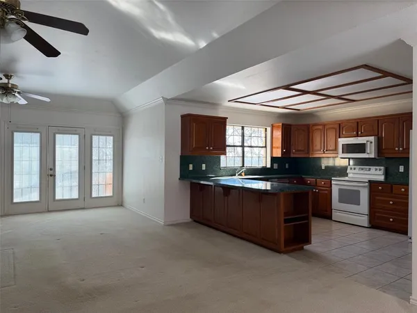 a large kitchen with stainless steel appliances granite countertop a stove and a sink