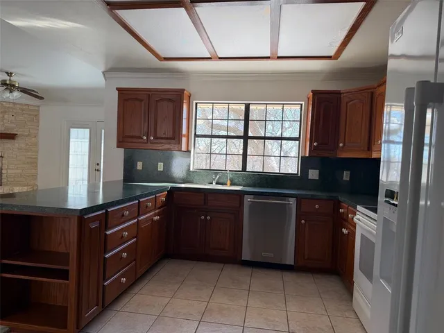 a kitchen with a sink window and cabinets