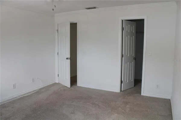 an empty room that has a grey walls
