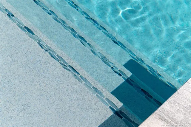 a view of a swimming pool and lounge chair
