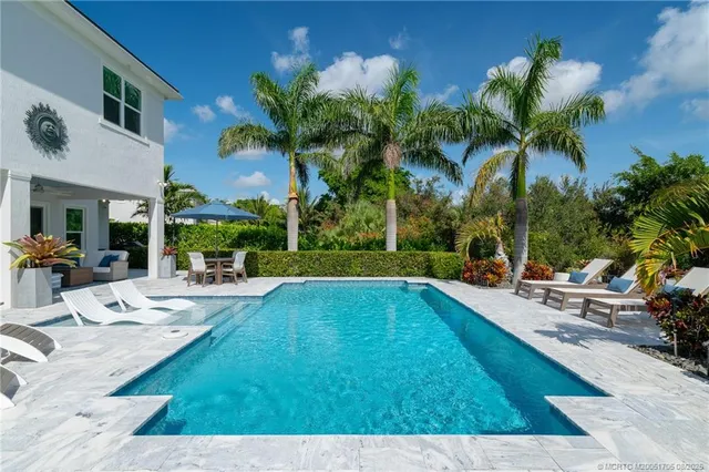 a view of an entryway with wooden floor and a livingroom view