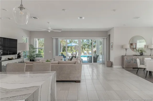 a large kitchen with kitchen island granite countertop lots of counter space and windows