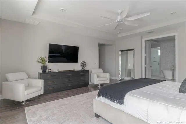 a bathroom with a bathtub shower sink mirror vanity and toilet
