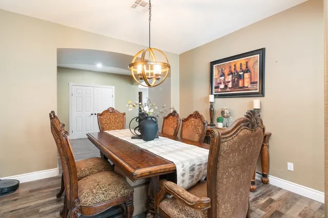 a view of a dining room with furniture wooden floor and chandelier