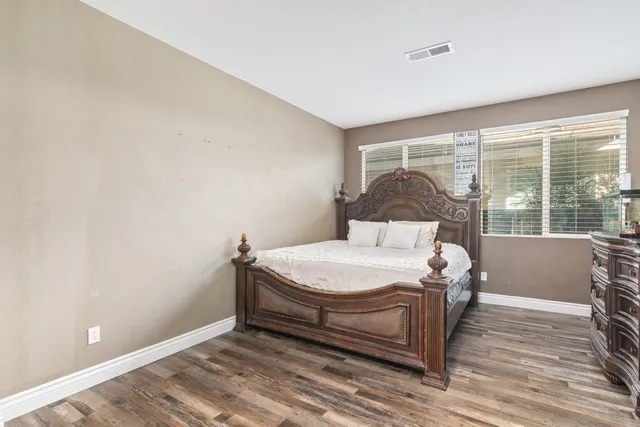 a bedroom with a bed and window