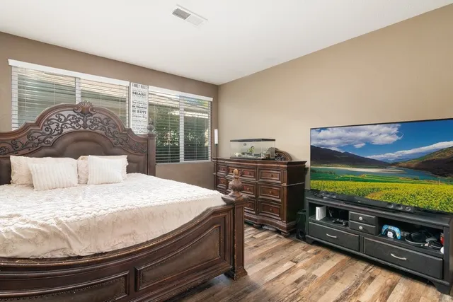 a bedroom with a bed and a flat screen tv