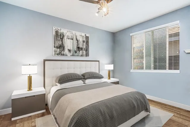 a bedroom with a bed and a window