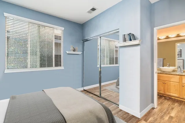 a bedroom with a bed and a large window