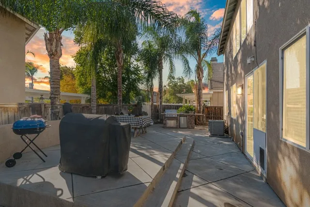 a view of a patio with table and chairs and potted plants