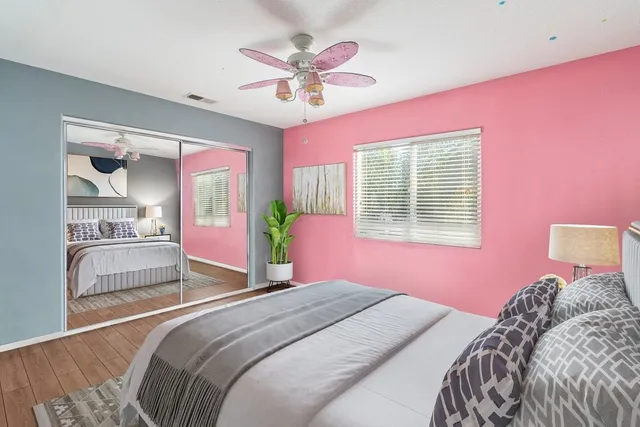 a bedroom with a bed dresser and a window