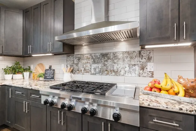 a stove top oven sitting inside of a kitchen