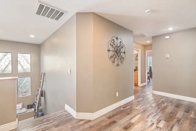 a view of a hallway with bathroom