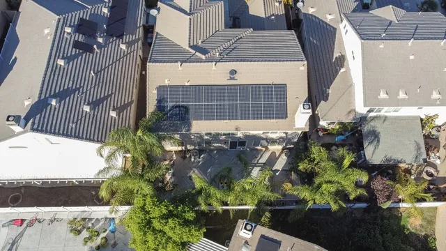 an aerial view of a house with a yard