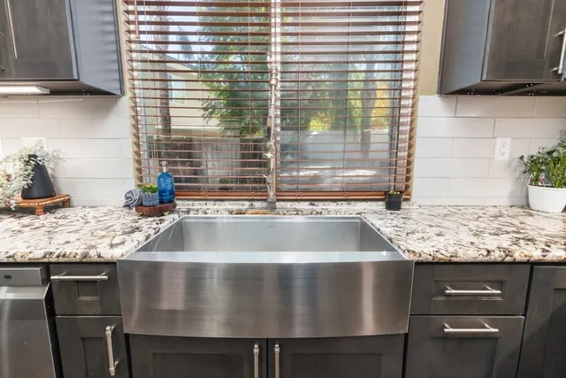 a kitchen with a sink and large window