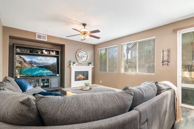 a living room with furniture a window and a flat screen tv