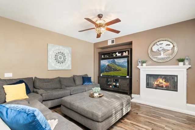 a living room with furniture a clock and a fireplace