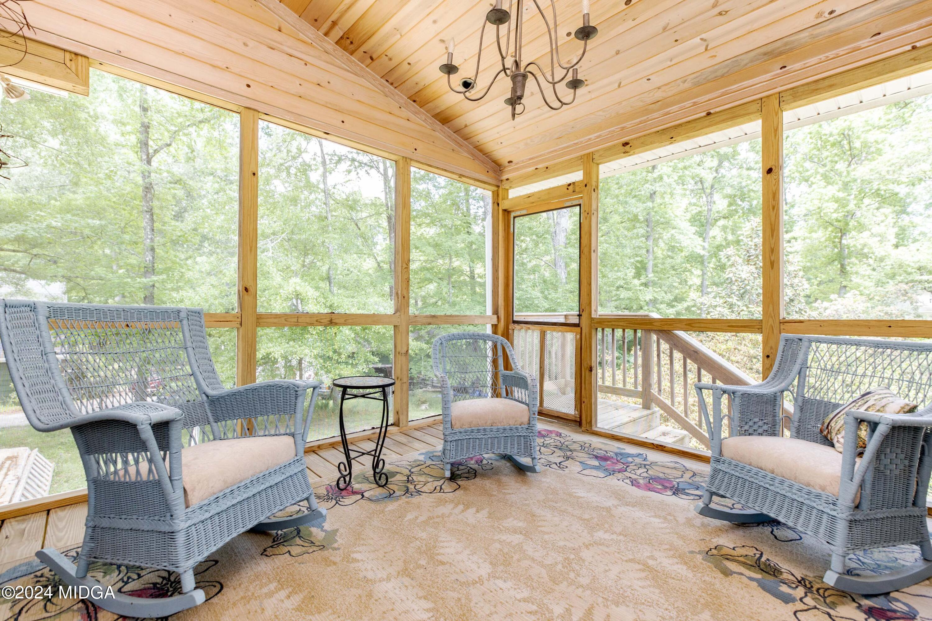 362 Stone Edge Road Macon, GA 31210 - Photo 40 of 68 a living room with furniture and a floor to ceiling window