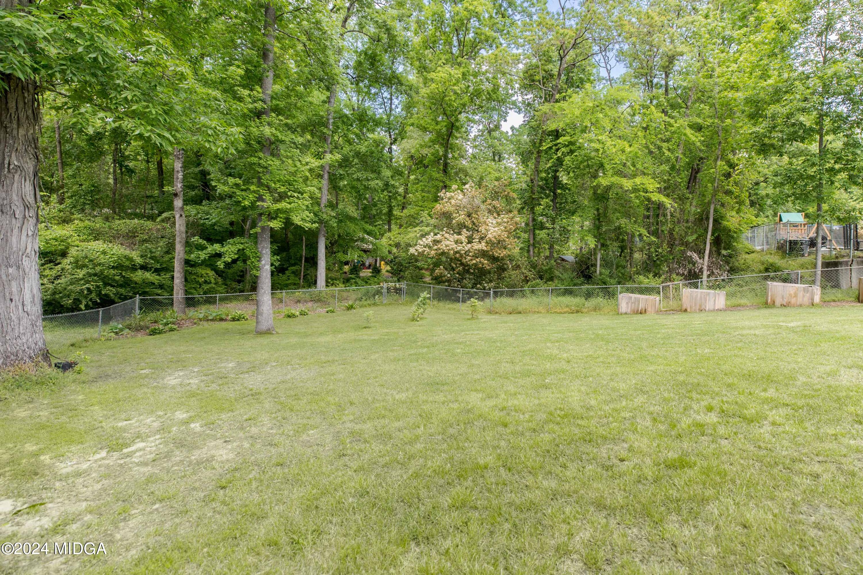 362 Stone Edge Road Macon, GA 31210 - Photo 68 of 68 a backyard of a house with plants and large trees