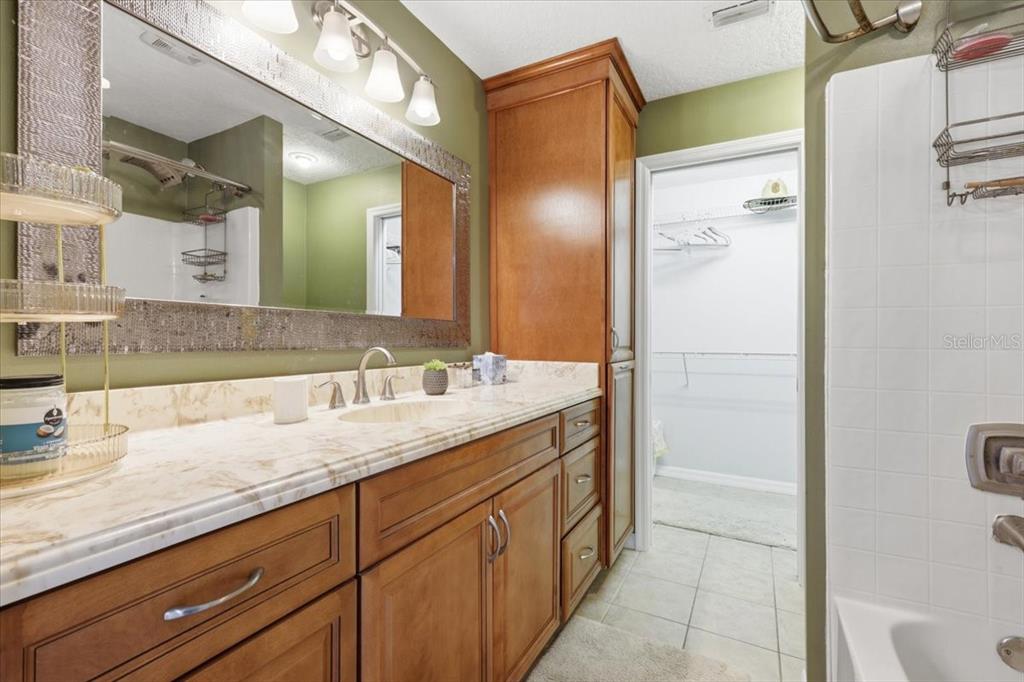 2329 River Ridge Road, Unit 2 DeLand, FL 32720 - Photo 11 of 17 a bathroom with a granite countertop sink and a mirror