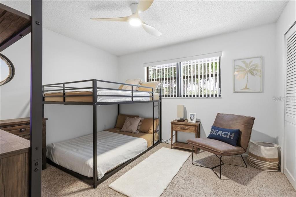 2329 River Ridge Road, Unit 2 DeLand, FL 32720 - Photo 12 of 17 a bedroom with a bunk bed and a table in it