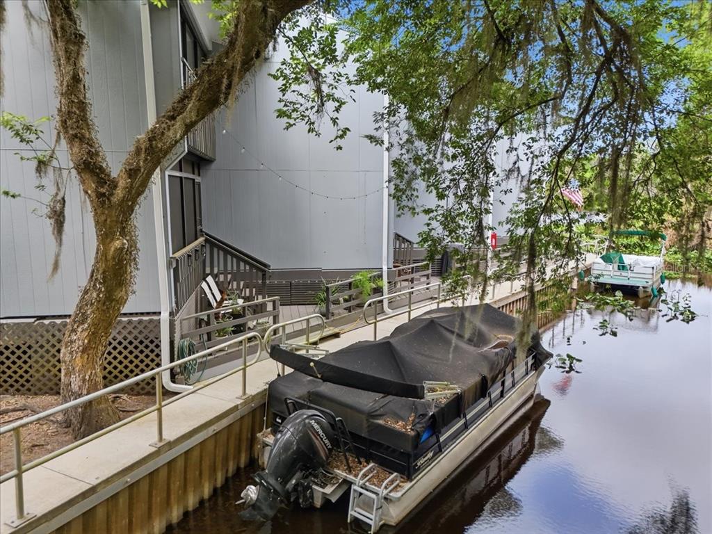 2329 River Ridge Road, Unit 2 DeLand, FL 32720 - Photo 17 of 17 a roof deck with table and chairs and potted plants