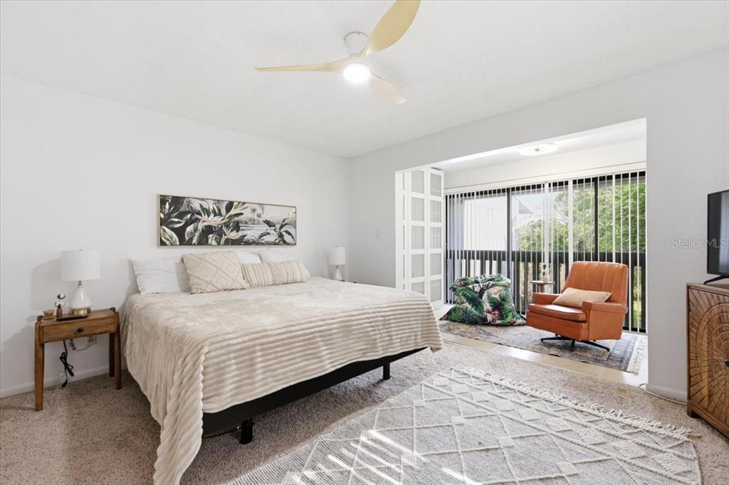 2329 River Ridge Road, Unit 2 DeLand, FL 32720 - Photo 9 of 17 a bedroom with a bed couch and a large window