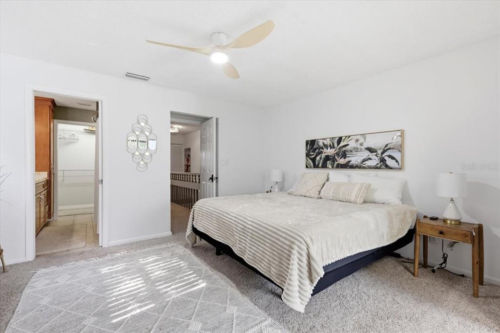 2329 River Ridge Road, Unit 2 DeLand, FL 32720 - Photo 10 of 17 a spacious bedroom with a bed and a table