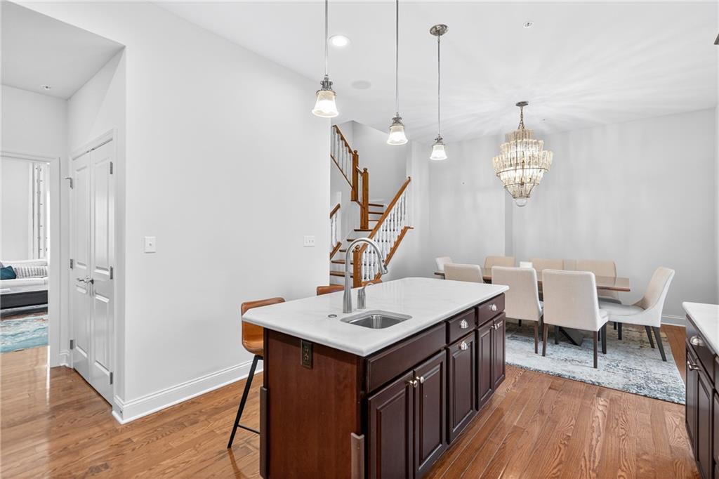 4709 Wallingford Street Pittsburgh, PA 15213 - Photo 12 of 39 a kitchen with a sink chandelier and wooden floor
