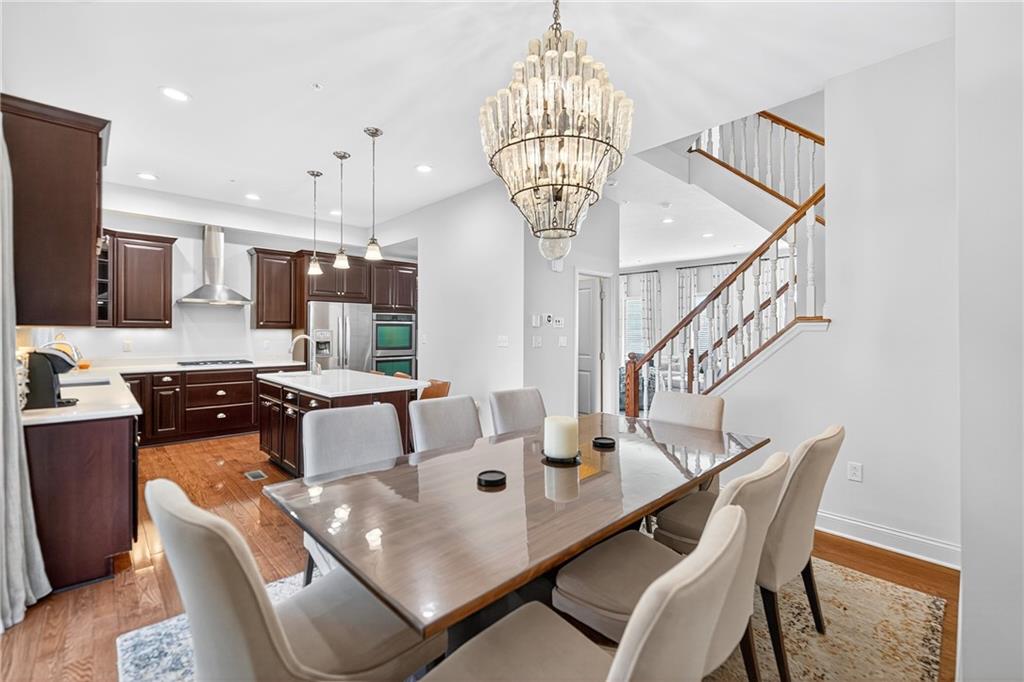 4709 Wallingford Street Pittsburgh, PA 15213 - Photo 13 of 39 a view of a dining room with furniture a chandelier and wooden floor