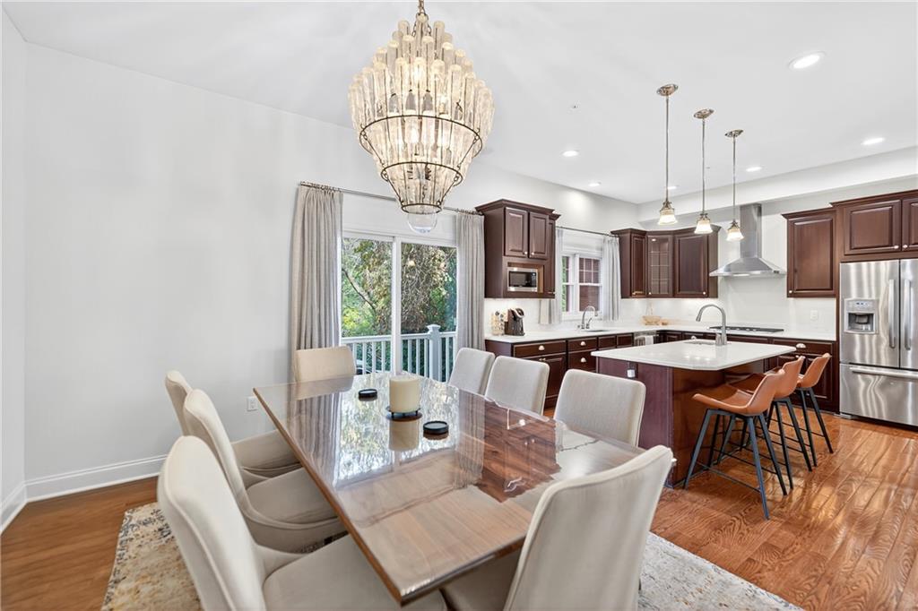 4709 Wallingford Street Pittsburgh, PA 15213 - Photo 14 of 39 a view of a dining room with furniture a chandelier and wooden floor