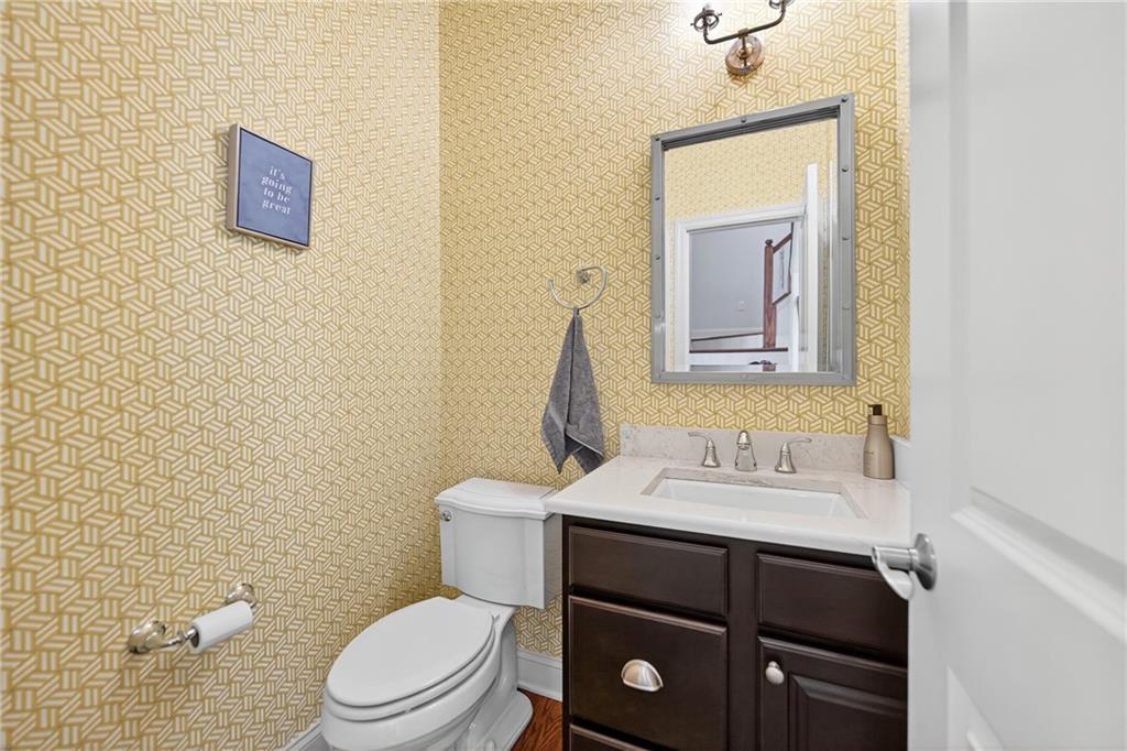 4709 Wallingford Street Pittsburgh, PA 15213 - Photo 17 of 39 a bathroom with a toilet sink vanity and mirror