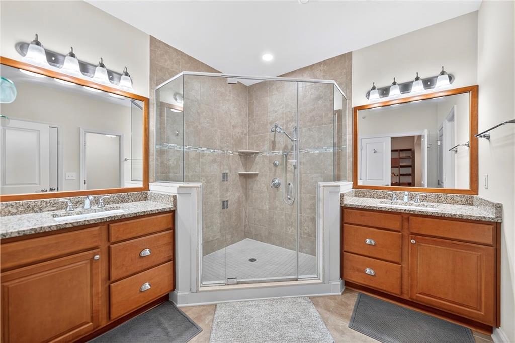 4709 Wallingford Street Pittsburgh, PA 15213 - Photo 20 of 39 a bathroom with a granite countertop sink a mirror a and a shower