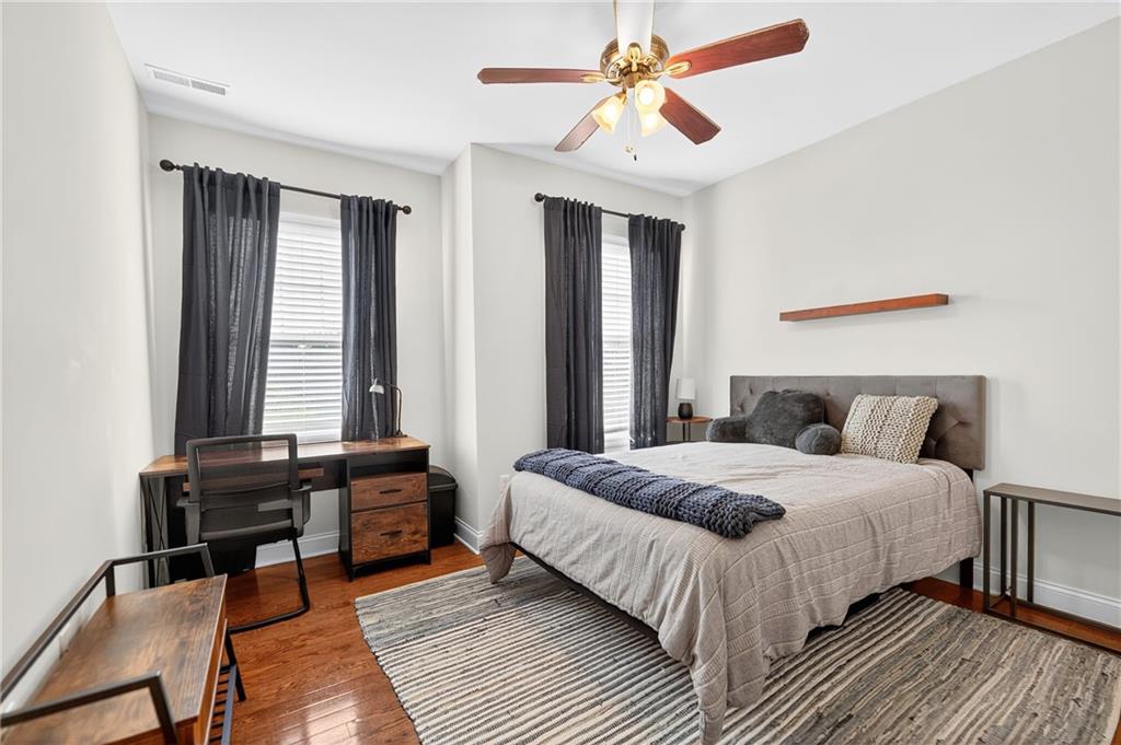 4709 Wallingford Street Pittsburgh, PA 15213 - Photo 23 of 39 a bedroom with a bed and a chandelier