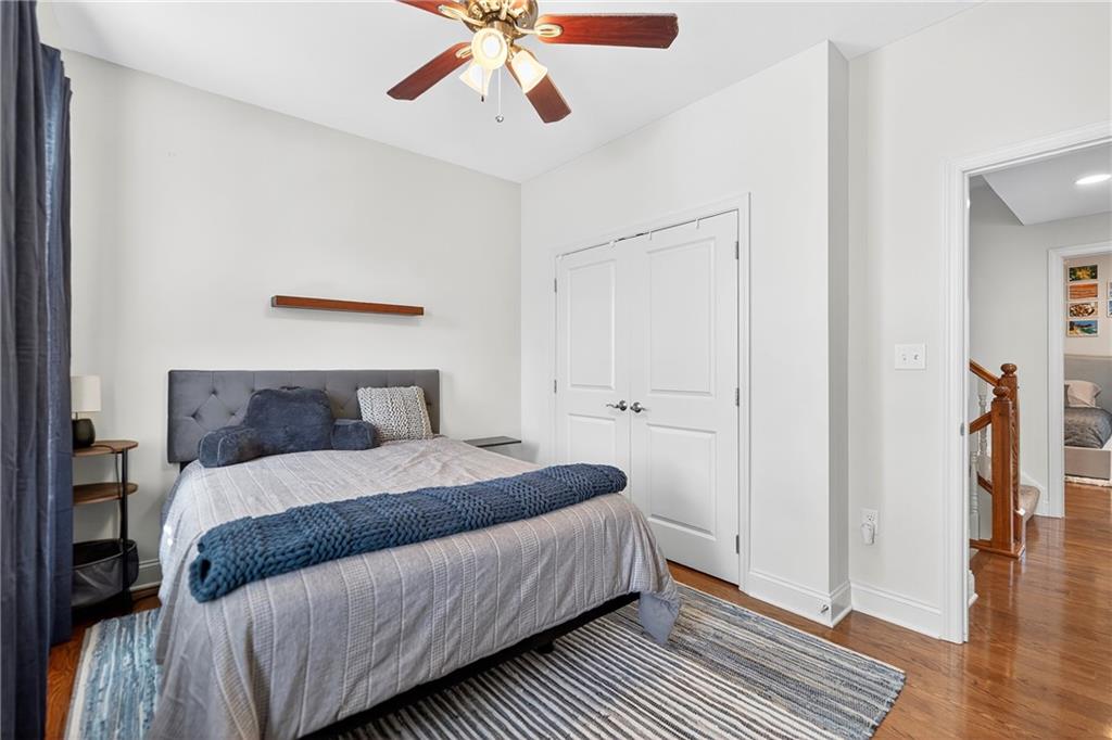 4709 Wallingford Street Pittsburgh, PA 15213 - Photo 24 of 39 a bedroom with a bed and wooden floor