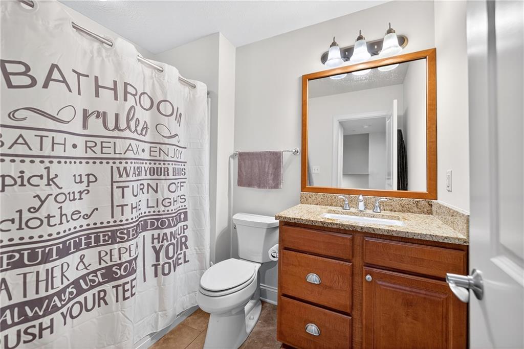 4709 Wallingford Street Pittsburgh, PA 15213 - Photo 25 of 39 a bathroom with a granite countertop toilet sink and mirror