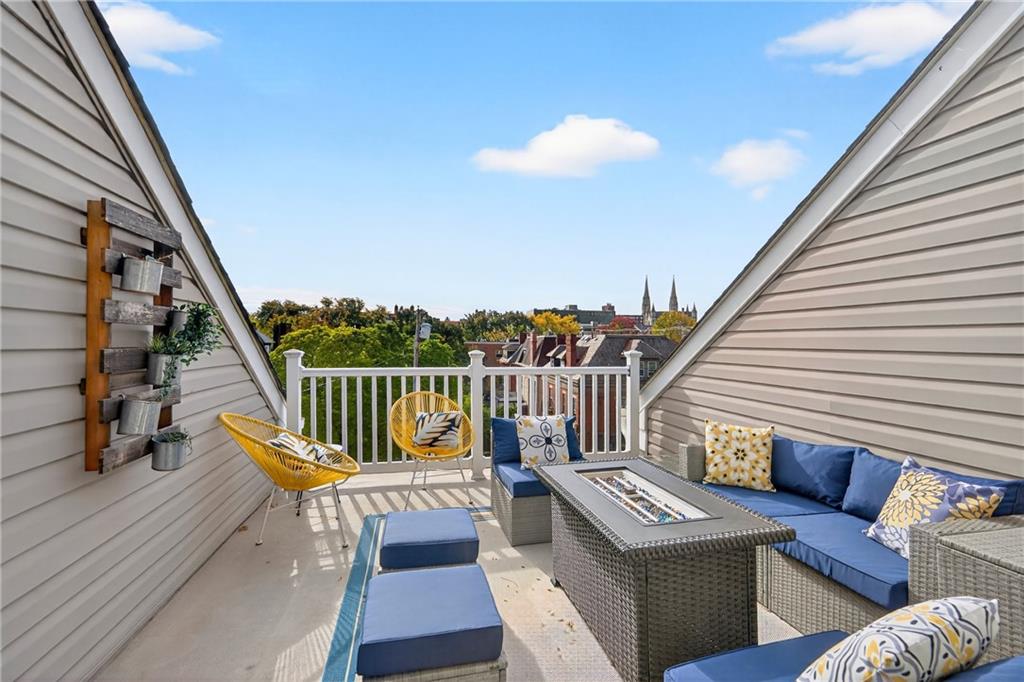 4709 Wallingford Street Pittsburgh, PA 15213 - Photo 33 of 39 a view of a balcony with wooden floor outdoor seating and stairs
