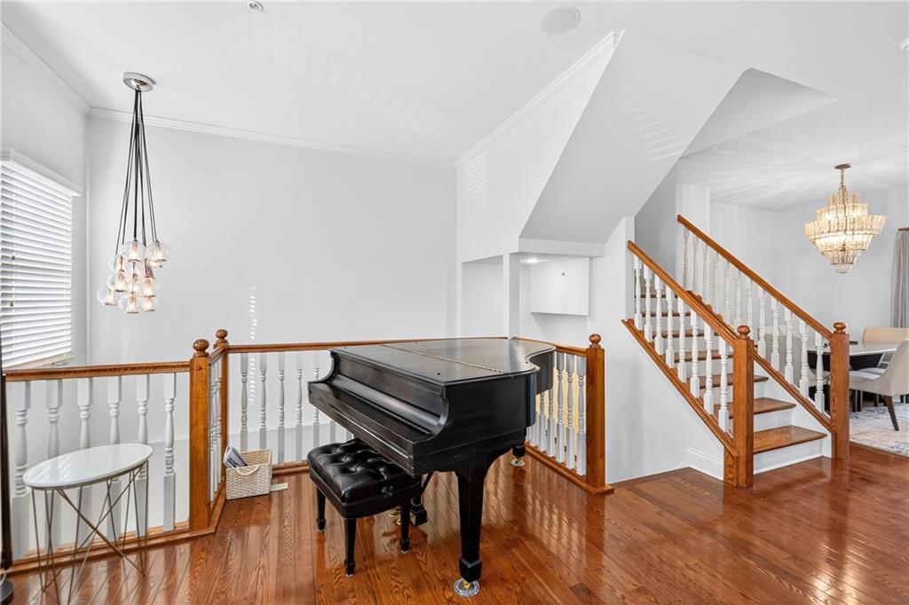 4709 Wallingford Street Pittsburgh, PA 15213 - Photo 6 of 39 a living room with a dining table a rug and wooden floor