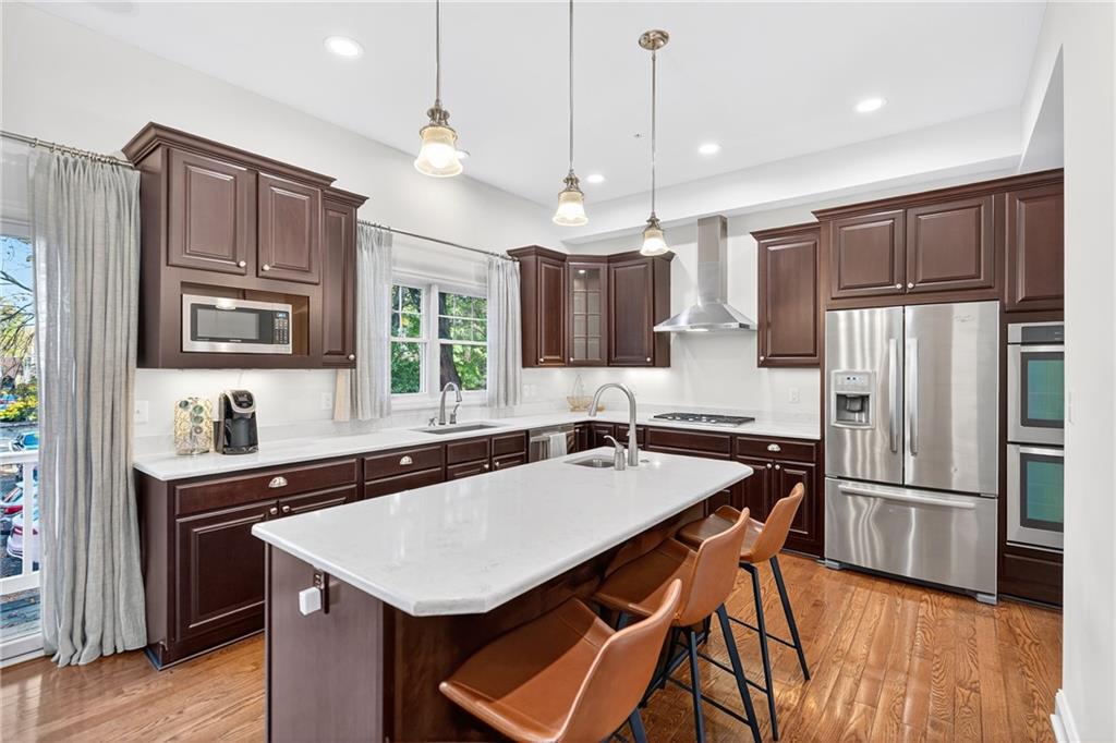 4709 Wallingford Street Pittsburgh, PA 15213 - Photo 8 of 39 a kitchen with granite countertop a sink a center island stainless steel appliances and cabinets