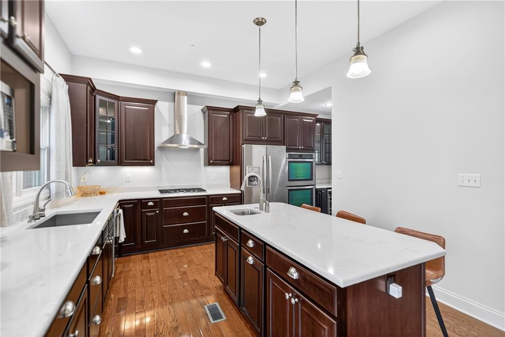 4709 Wallingford Street Pittsburgh, PA 15213 - Photo 9 of 39 a kitchen with a sink a counter top space stainless steel appliances and cabinets